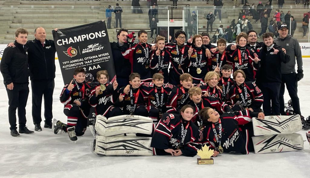 Myers U12 team with championship banner